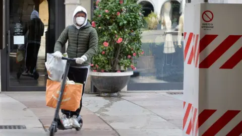 Getty Images A man goes shopping in Italy (file pic)