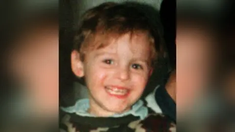 PA Media Toddler James Bulger smiles at the camera