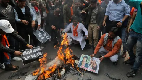 Reuters Right wing Hindus burn photos of Mr Azhar and Pakistani Prime Minister Imran Khan