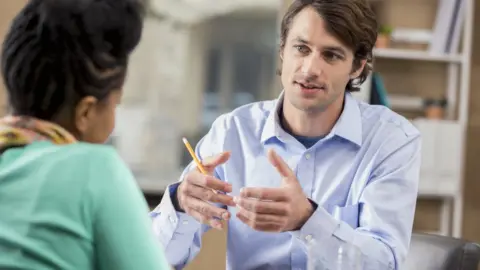 Getty Images man interviews woman