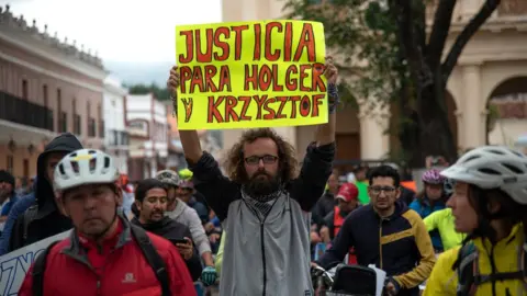 EPA Friends of killed European cyclists Holger Hagenbusch and Krzysztof Chmielewski protest in San Cristobal de las Casas, 6 May 2018