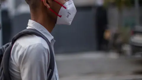 Getty Images A Delhi school boy with a shoulder bag looks on