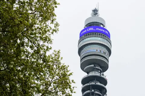 Anthony Upton / PA Media A digital message, which reads Less URL, more IRL. Welcome back is displayed on the BT Tower above the streets of London