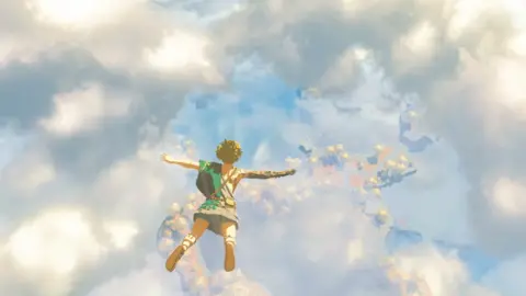 Link, the character from the Zelda series, skydives through a cloudy blue sky in this screenshot