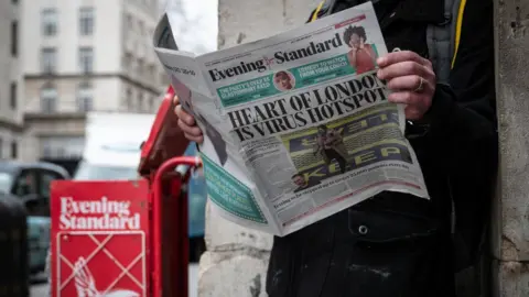 Getty Images Man reading Evening Standard during the pandemic