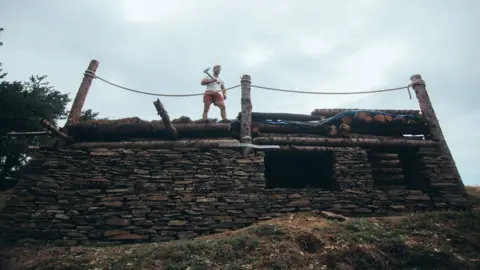 Joshua Rhys Photography Mike Allen standing on his new cabin