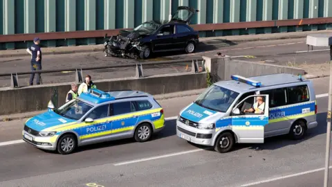 Reuters Police officers investigate the scene of a series of allegedly deliberate car crashes on highway A100 in Berlin, Germany, August 19, 2020