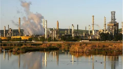 Getty Images Smoke drifts away from a Shell Oil refinery