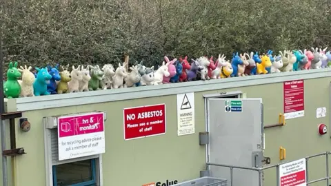 BBC Inflatable toys on a building at a recycling centre