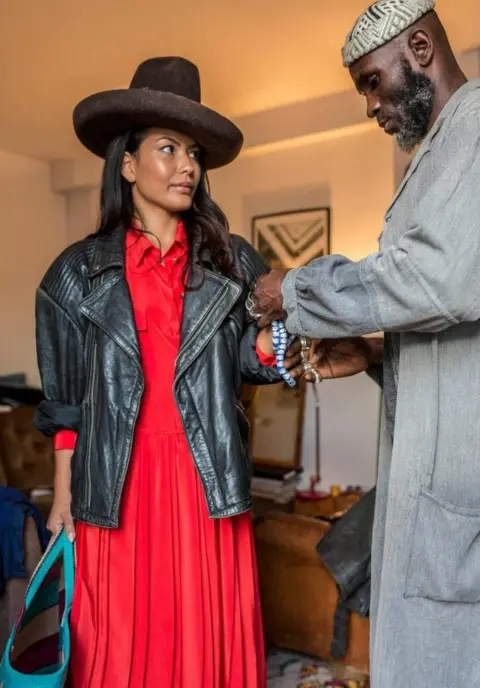 Andrew Esiebo Amah styling a client in Paris