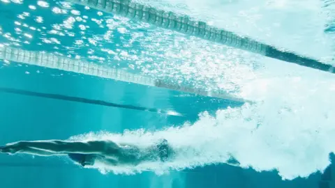 Getty Images A woman using an indoor swimming pool