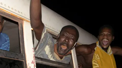 Reuters Guinea prisoners celebrating their release.