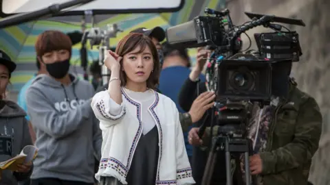 Getty Images Actor Choi Yoon-so stands by on the set of a South Korean TV drama Bong's Happy Restaurant