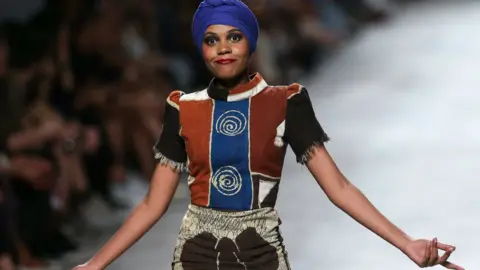 EPA A model shows off a creation by Angolan fashion designer Nadir Tati on Sunday during her show at Lisbon Fashion Week in Lisbon