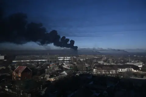 AFP Black smoke rises from a military airport in Chuhuiv near Kharkiv on February 24, 2022