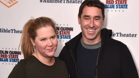 Getty Images Amy Schumer and husband Chris Fischer