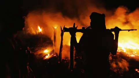 Getty Images An armed Sudanese rebel from the Justice and Equality Movement (JEM) arrives at the abandoned village of Chero Kasi less than an hour after Janjaweed militiamen set it ablaze in the violence plagued Darfur region September 7, 2004.