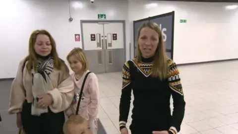 BBC Two women and a girl at an airport