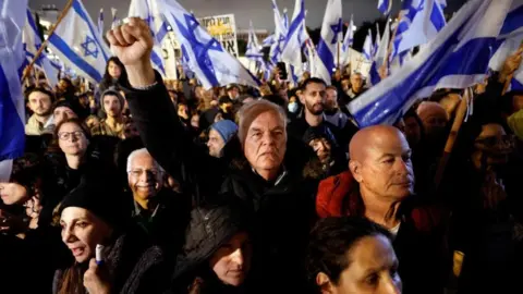 Israelis protest against Prime Minister Benjamin Netanyahu's new right-wing coalition and its proposed judicial reforms to reduce powers of the Supreme Court in a main square in Tel Aviv, Israel January 14, 2023.