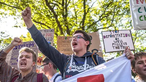 PA Media Several young people in Edinburgh protesting against climate change