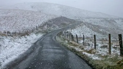 BBC Weather Watcher Lewis Snow in fields along a country road in Rostrevor in County Down