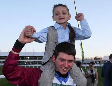 Aintree Racecourse/John Grossick  Bradley Lowery with Derek Fox