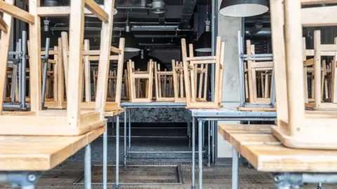 Getty Images Generic image of stools of tables in restaurant during pandemic