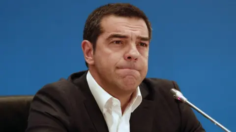 EPA Alexis Tsipras speaks to reporters with a furrowed brow, pursing his lips