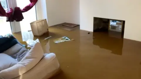 B D Roberts In one home floodwater can be seen filling the living room