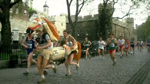 Getty Images A pantomime horse runs past the Tower of London during the marathon in 1982