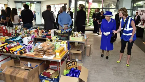 PA The Queen being shown food supplies