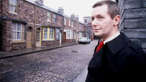 Granada TV/PA Wire Tony Warren on Coronation Street in 1985