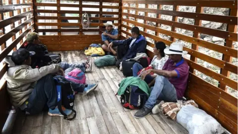 AFP Venezuelan migrants travel in the back of a truck on the Pan-American highway, between Pasto and Ipiales, Colombia on their way to Peru, on August 23, 2018.