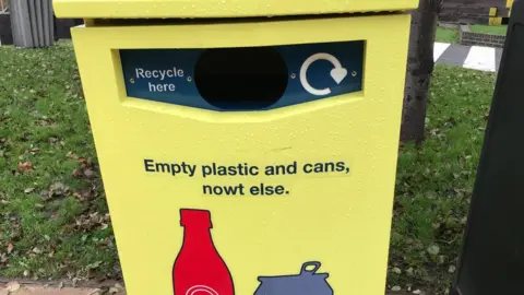 Yellow recycling bin