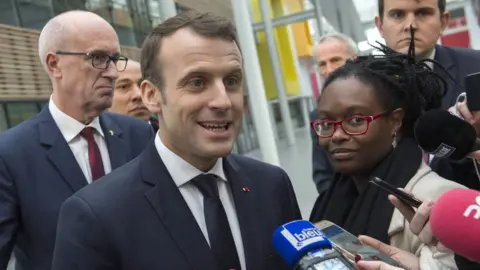 Getty Images French President Emmanuel Macron gives a press point next to his Public Relations advisor Sibeth Ndiaye (R) during a visit at the Michelin Ladoux Research and Technology centre in Ladoux, central France, on January 25, 2018