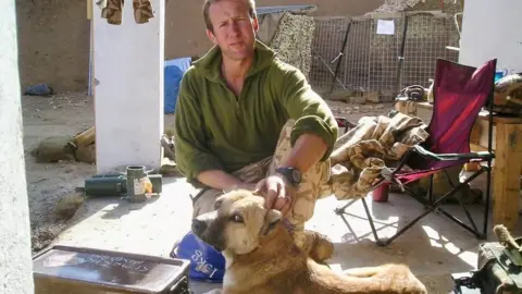 Nowzad Pen Farthing with a rescue dog