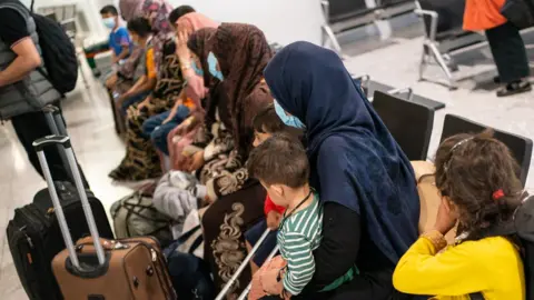 Getty Images Refugees from Afghanistan at Heathrow Airport in 2021