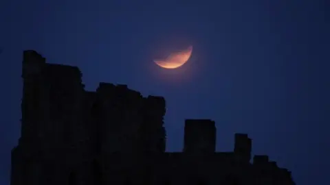 PA Media Partial lunar eclipse on 16 July 2019, from Tynemouth Priory