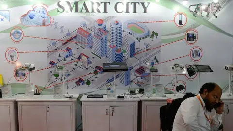 Getty Images An Indian delegate talks on a phone during the Smart Cities India 2016 expo in New Delhi on May 12, 2016.