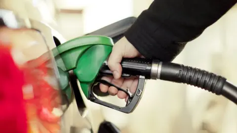 Getty Images Hand at petrol pump