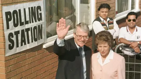Getty Images Then Prime Minister John Major and his wife Norma voting in the 1997 general election