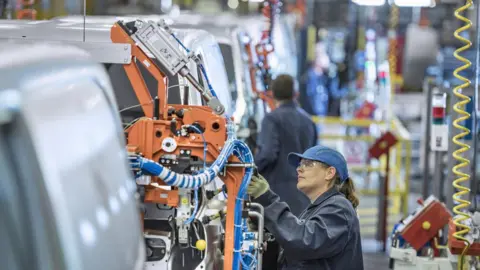 Getty Images A woman on a car production line