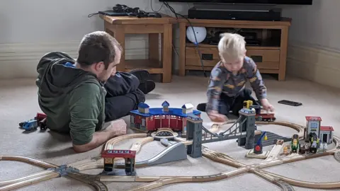 Claire Millington Claire Millington's husband and son play wooden railways during lockdown in the UK