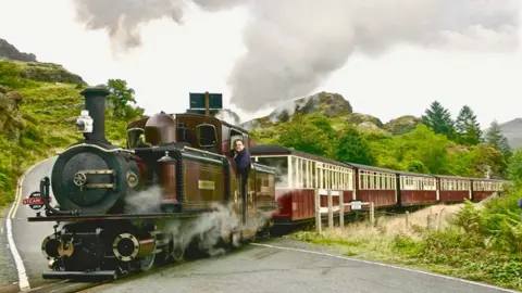 Mel Evans Ffestiniog and Welsh Highland Railways locomotive near Tanygrisiau crossing a road