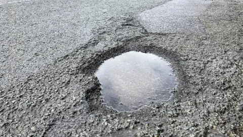 BBC A pothole on a main road in Stockwood, Bristol