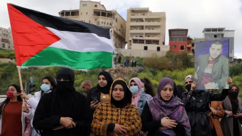Reuters Israeli Arabs protest against what they say is a wave of violence against their community and police inaction, in the Israeli town of Umm al-Fahm, Israel (12 March 2021)