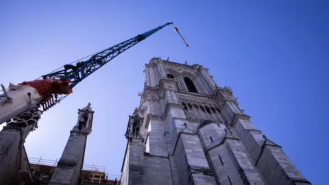 Getty Images A crane looms over Notre-Dame cathedral in Paris