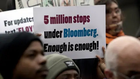 Getty Images At a protest someone holds a sign that says five million stops under Bloomberg. Enough is enough!
