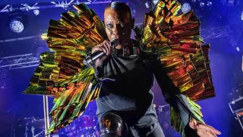 Getty Images Skunk Anansie star Skin became the first black British singer to headline Glastonbury Festival in 1999