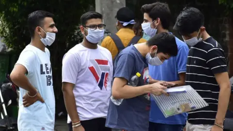 Getty Images Students discuss the JEE paper after coming out from the exam centre